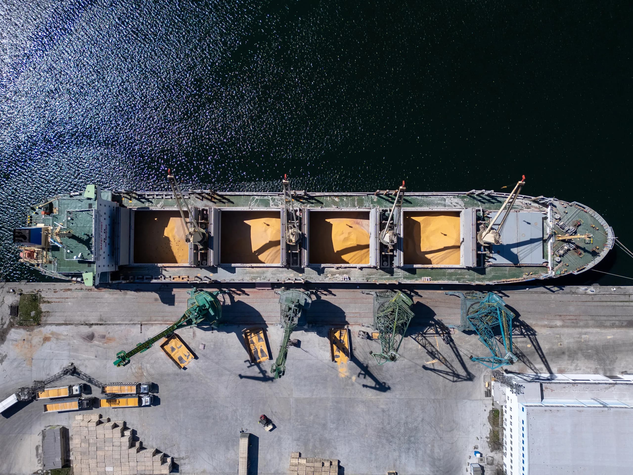 Aerial view of a bulk carrier being loaded with grain at port
